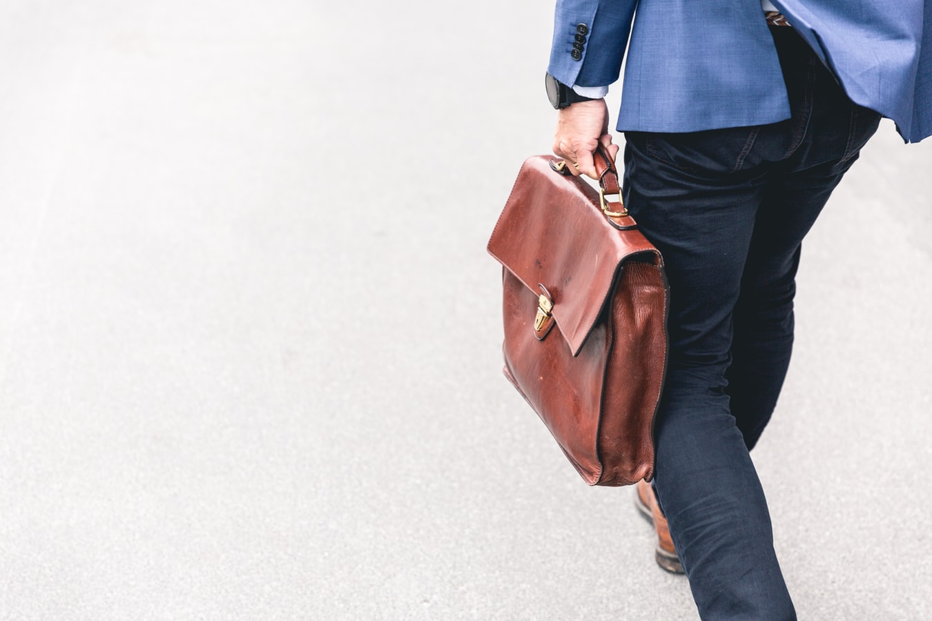 Un homme en route pour le travail avec un sac en main.